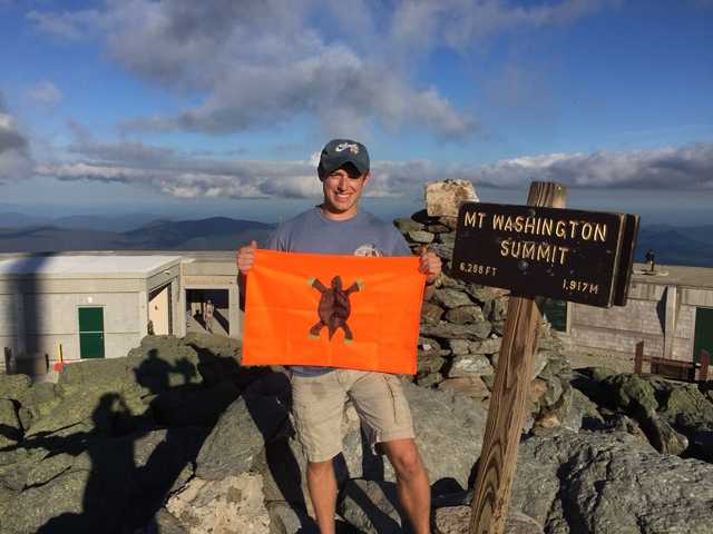 Mount Washington summit sign and rocks in evening light