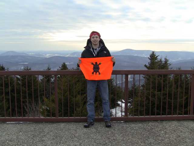 Overlook railing on Spruce Knob with snow-dusted ridges behind