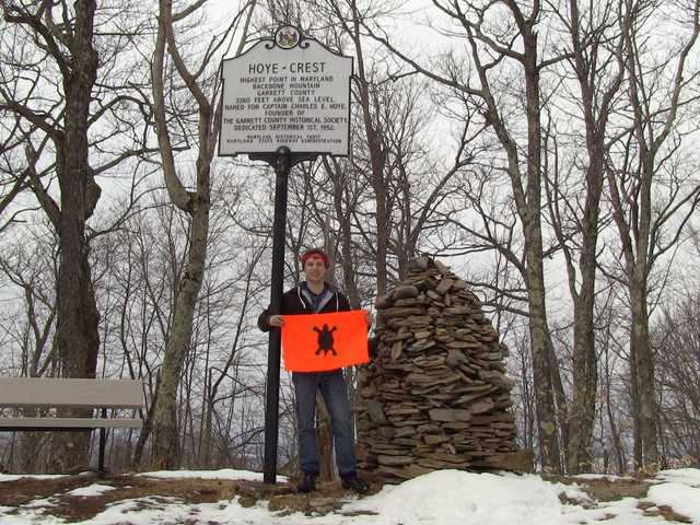 Hoye-Crest historical marker and a tall rock cairn in winter