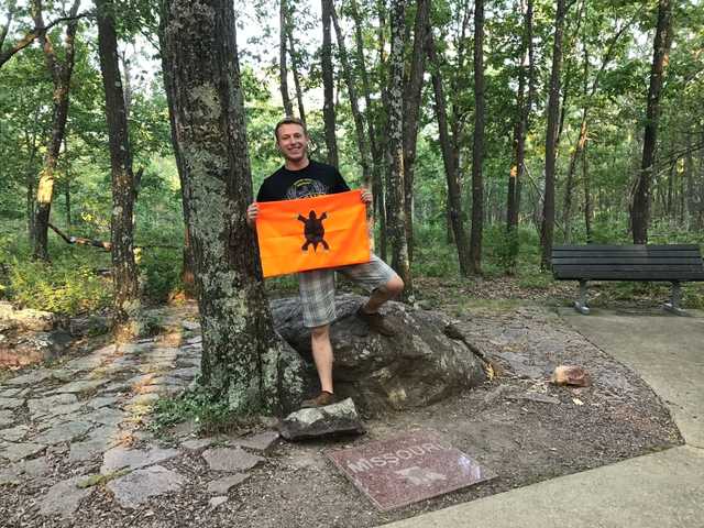 Missouri highpoint marker in the woods on Taum Sauk Mountain