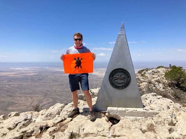 Steel summit pyramid on Guadalupe Peak above the desert