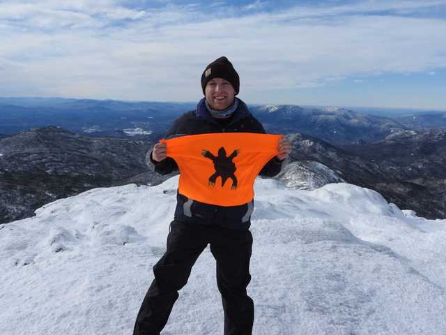 Snowy summit of Mount Marcy with the Adirondacks behind